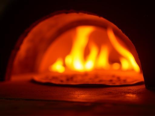 Interior view of the glowing wood-fired pizza oven
